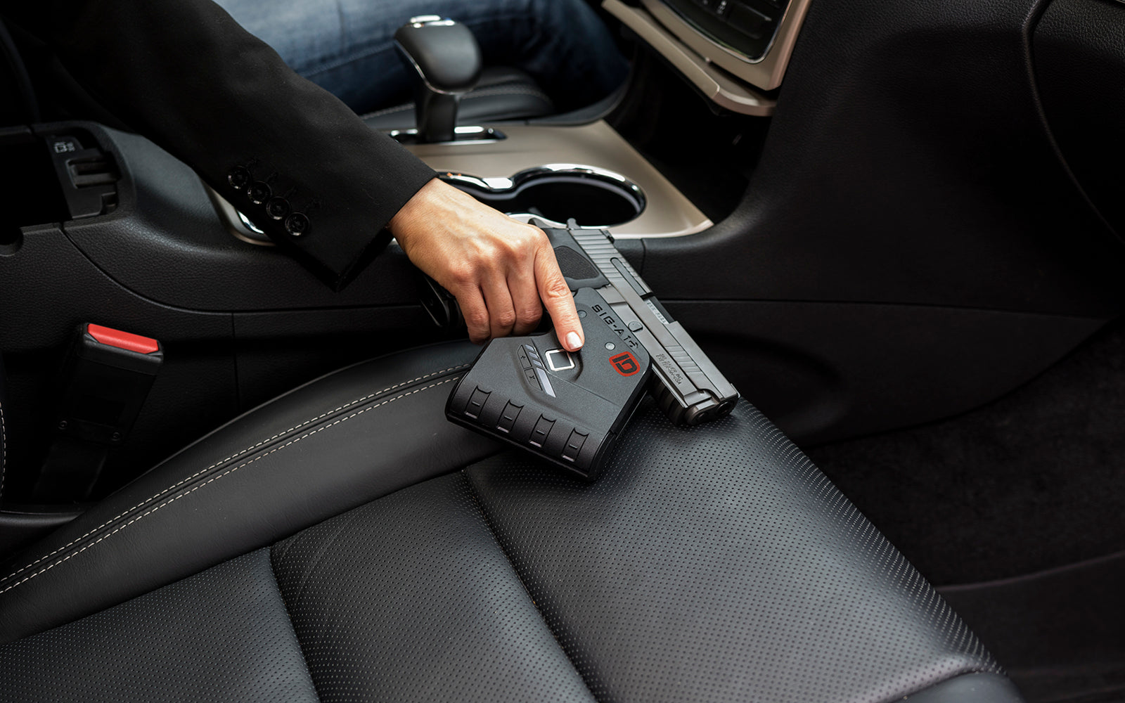Woman holding IDENTILOCK–Biometric Fingerprint gun lock in car